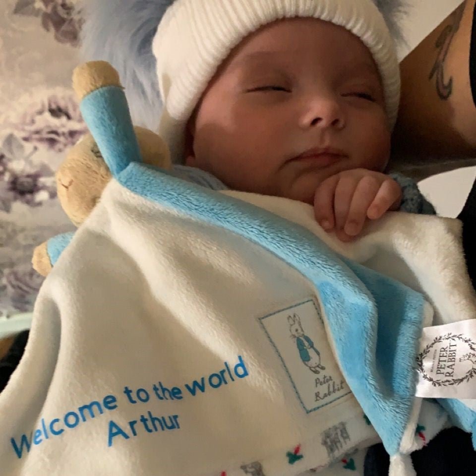 Personalised Peter Rabbit blanket with name beside Peter Rabbit logo