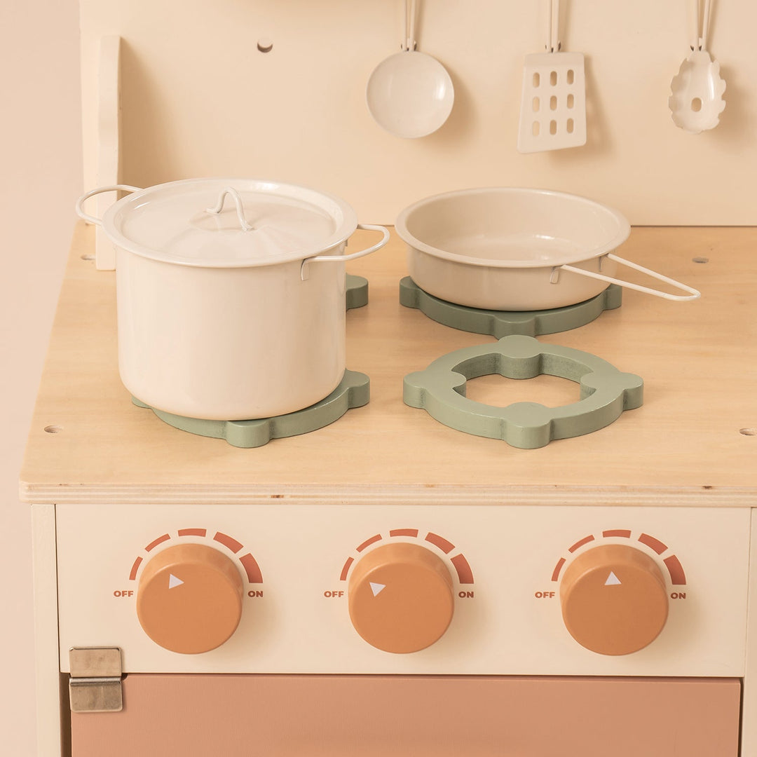 Rustic Wooden Kitchen with Cooking Utensils, Pans, Apron, Gloves and Leaf Light String - Chic Petit